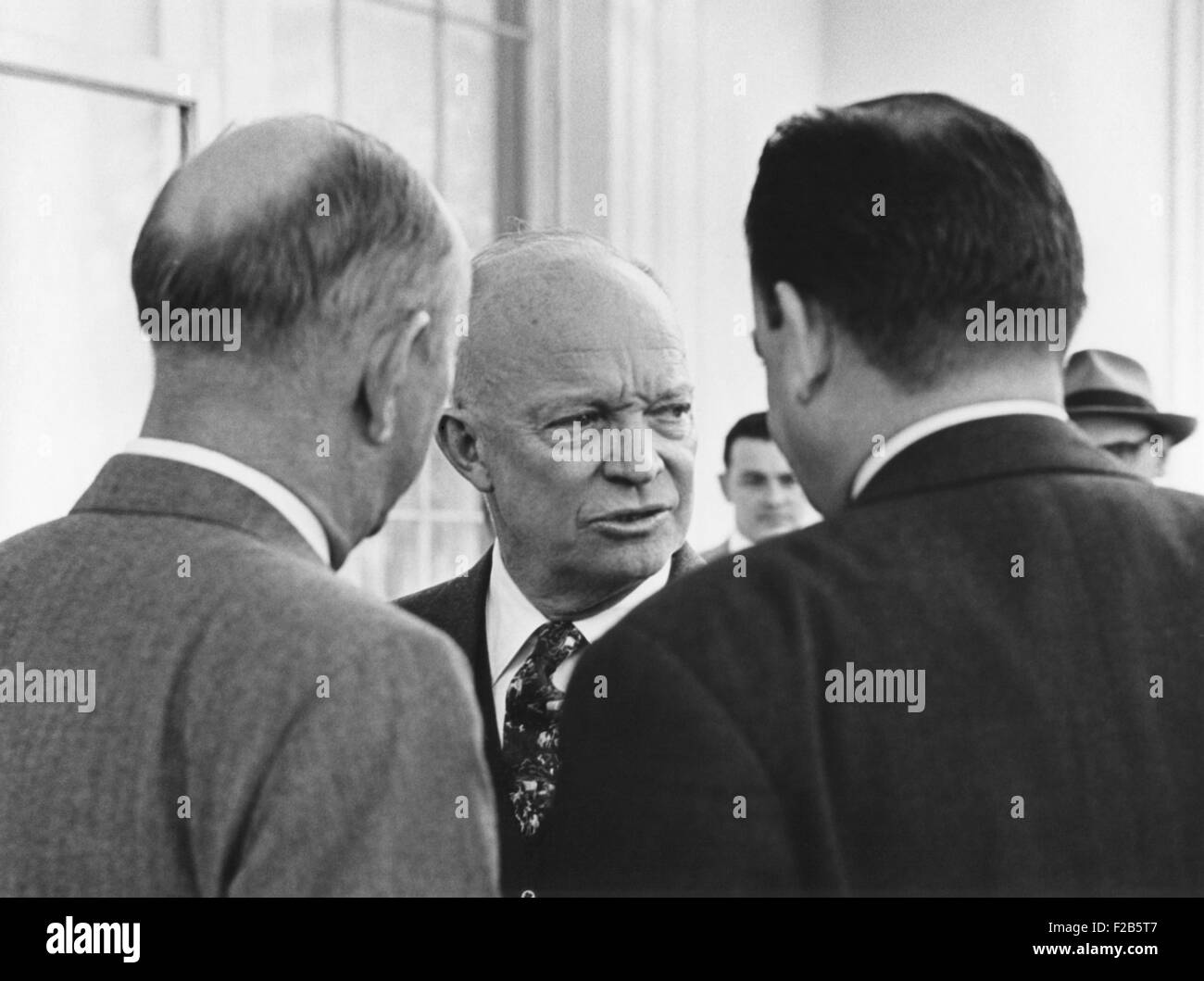 Candid portrait of President Eisenhower in conversation with unidentified men on March 31, 1955. - (BSLOC 2014 16 61) Stock Photo