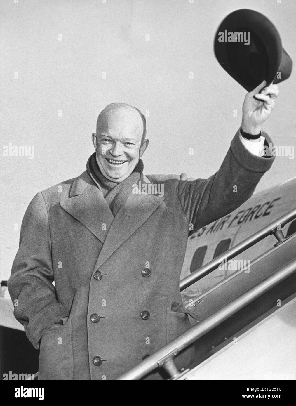 President Eisenhower waving his hat from airplane steps. He was leaving for a for a Christmas vacation at Augusta National Golf Stock Photo