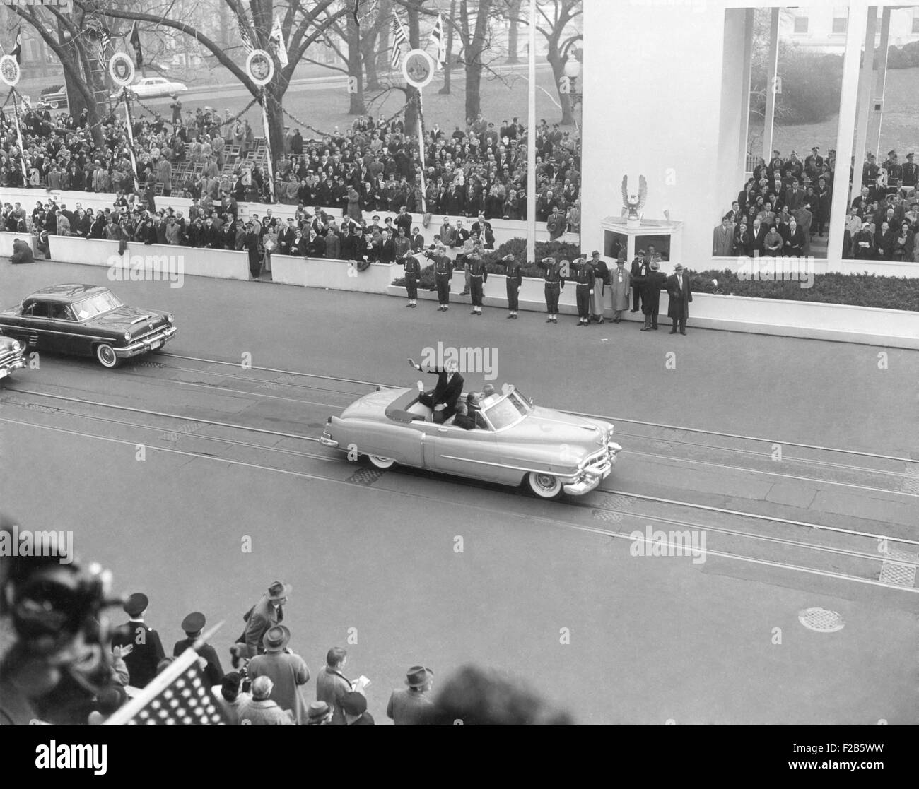 Vice President Richard Nixon standing in an open car in the inaugural parade. Jan. 20, 1953. Pat Nixon's white glove waves to the crowd. - (BSLOC 2014 16 25) Stock Photo
