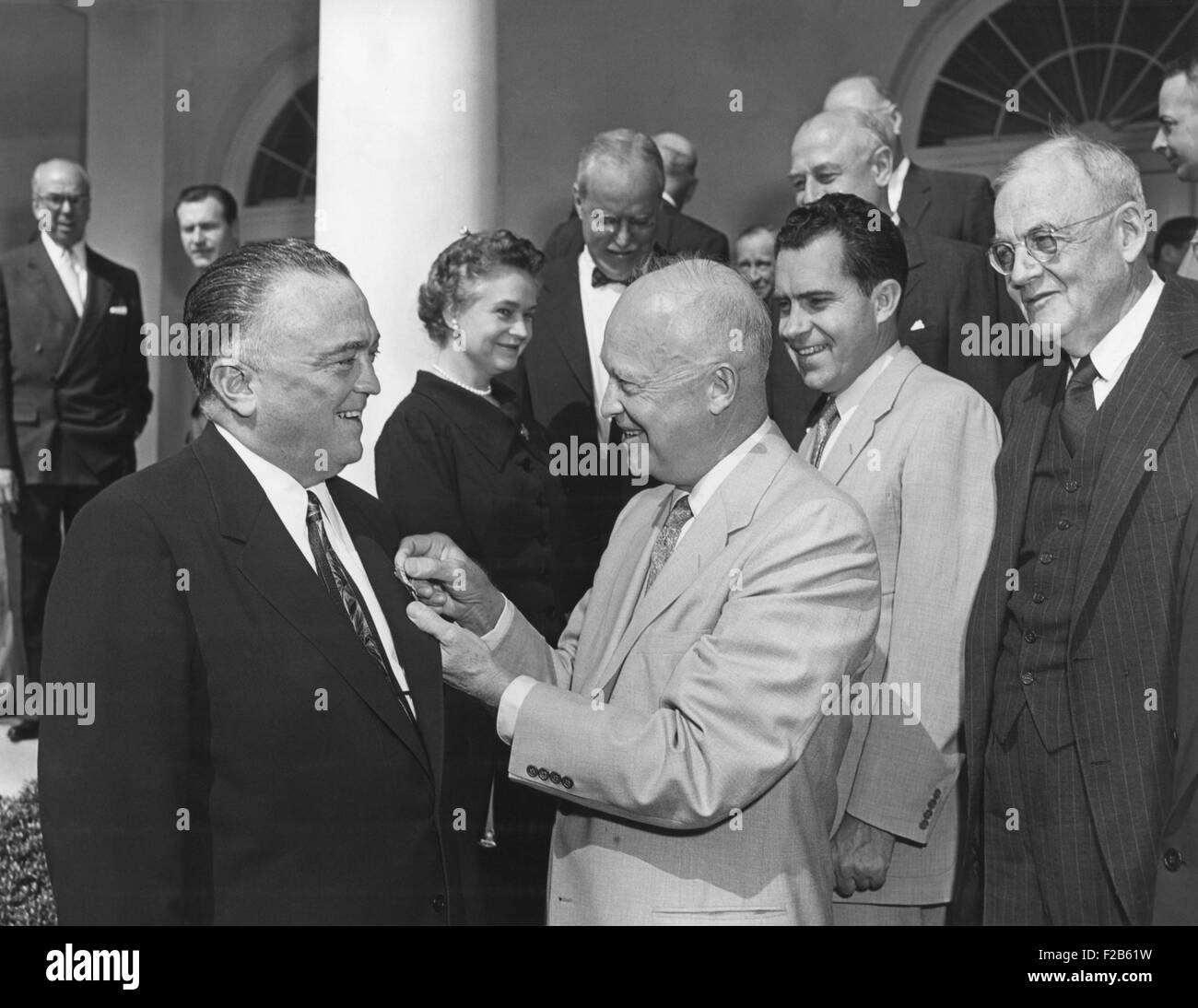 President Eisenhower presents the National Security Medal to FBI Director J. Edgar Hoover. Ceremony attended by a Cabinet group Stock Photo