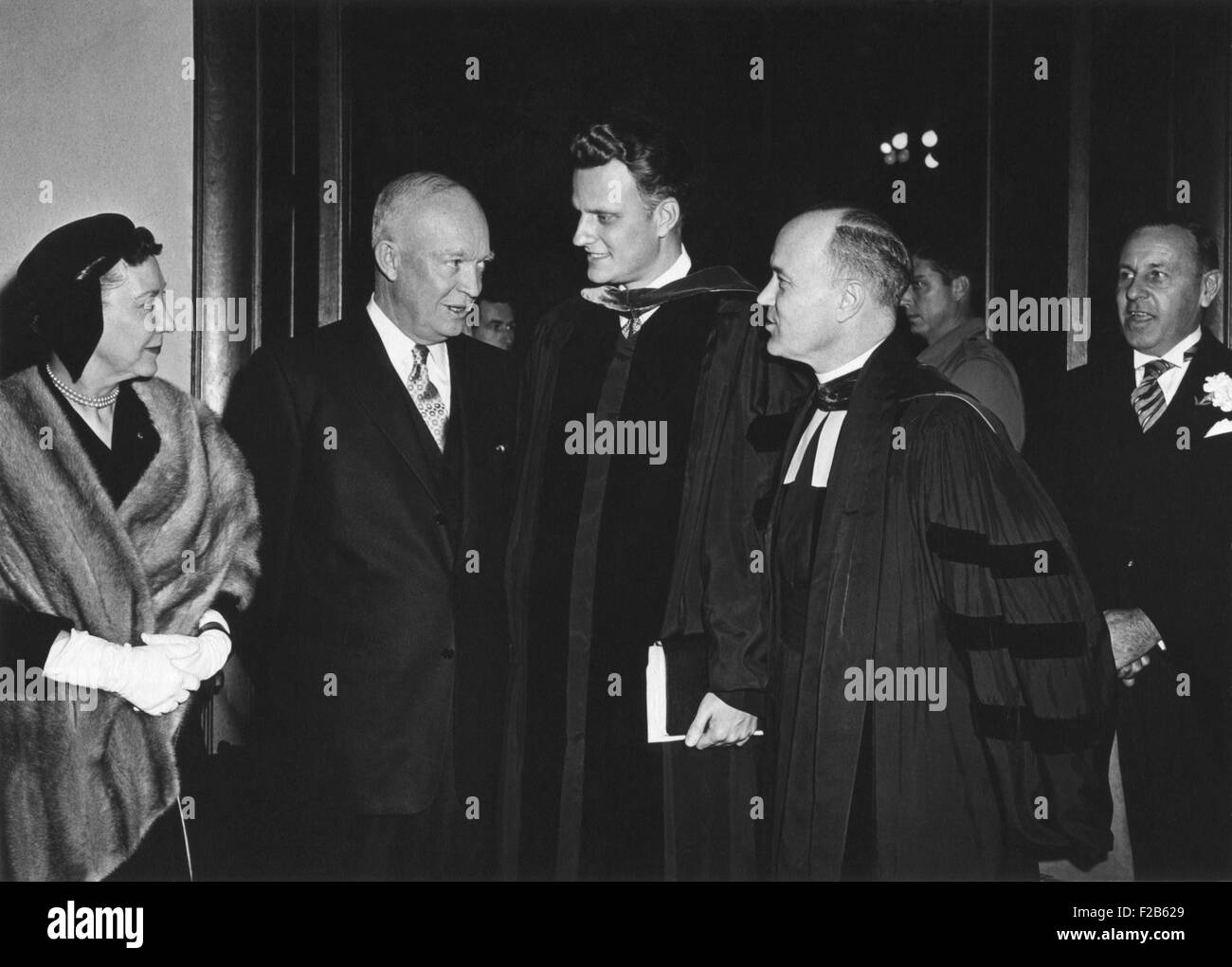 President and Mamie Eisenhower leaving National Presbyterian Church, March 6, 1955. Eisenhower speaks with Evangelist Billy Graham. L-R: First Lady, the President, Rev. Billy Graham, Dr. Edward Elson. - (BSLOC 2014 16 169) Stock Photo