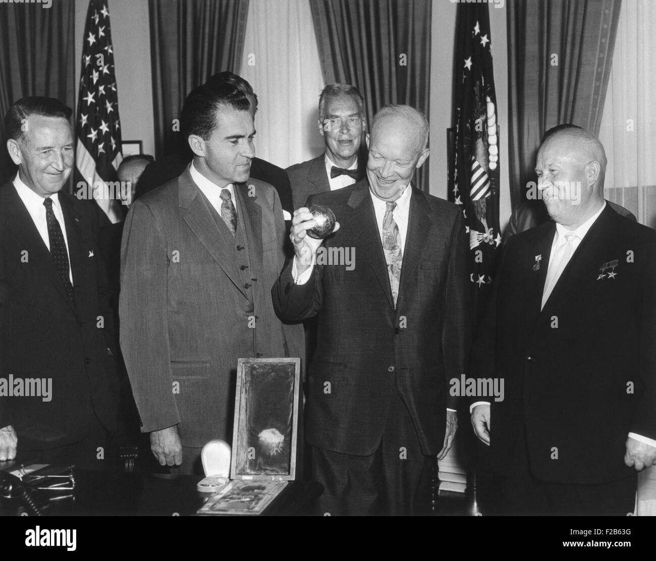 President Eisenhower holding a gift from Soviet Premier Nikita Khrushchev. It was a replica of metal ball, 7.5 cm in diameter, launched to the lunar surface in Luna 2. Shaped like a soccer ball, it bore the Soviet hammer and sickle seal. Sept 15, 1959. L-R: Llewellyn Thompson, Richard Nixon, Christian Herter, Dwight Eisenhower, Nikita Khrushchev. - (BSLOC 2014 16 147) Stock Photo