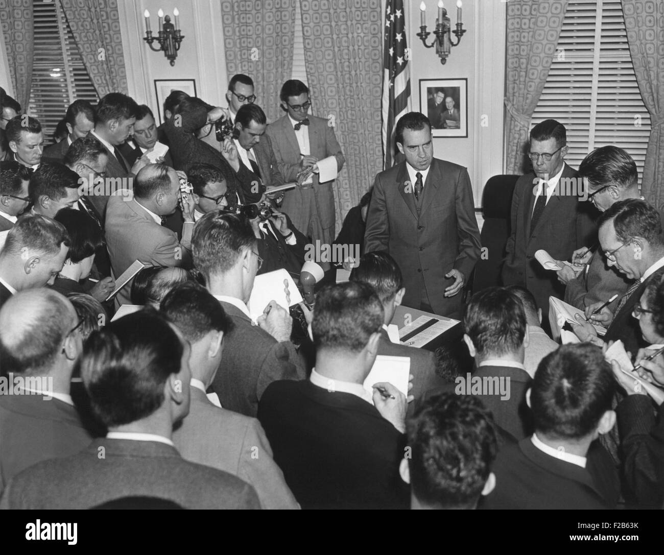 Vice President Richard Nixon with reporters on Nov. 27, 1957. Nixon answered questions about Eisenhower's mild stroke that occurred in the Oval Office on Nov. 25, 1957. Eisenhower's Press Secretary, James Hagerty is on Nixon's left. - (BSLOC 2014 16 144) Stock Photo