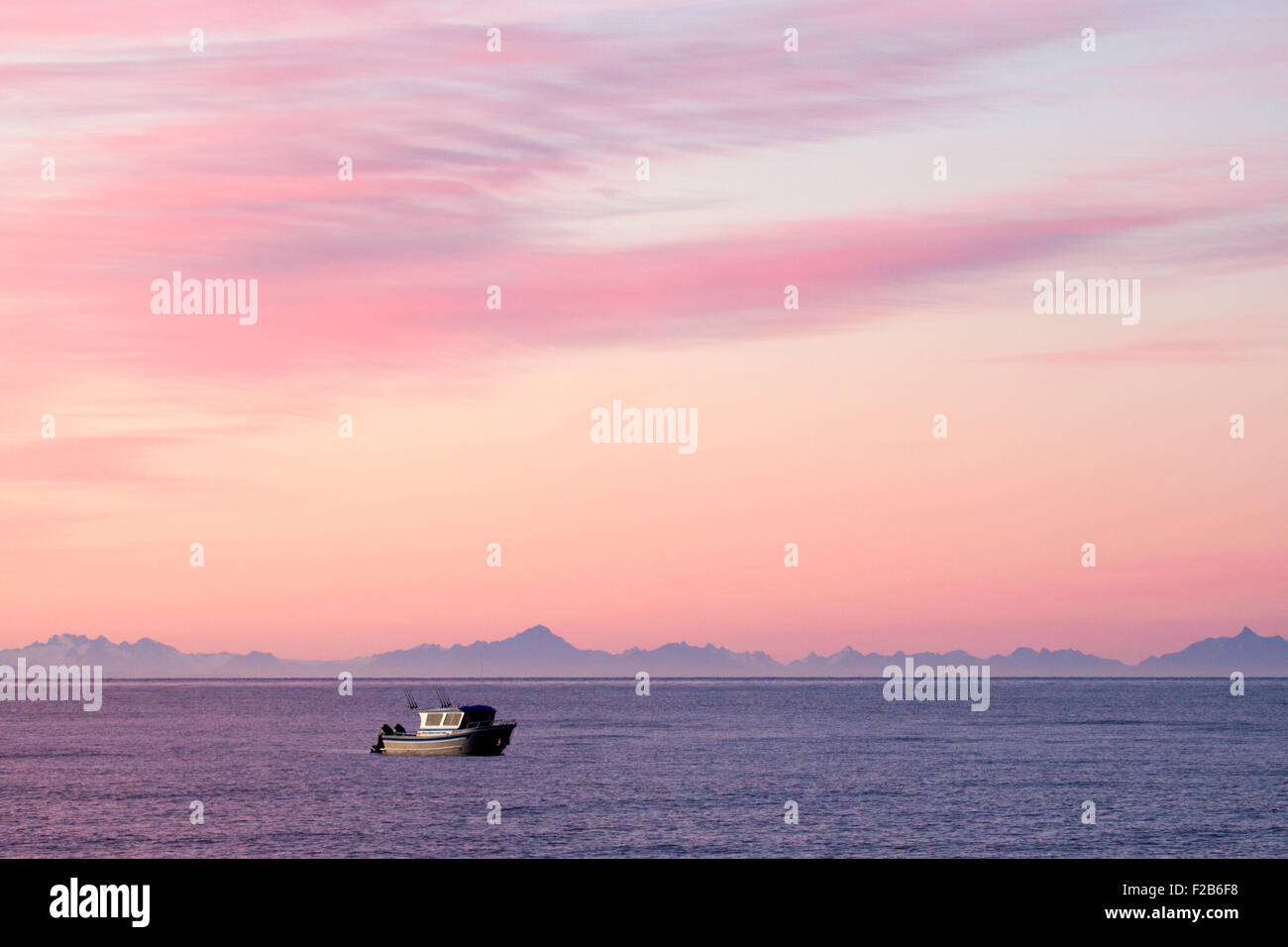 Small Boat on Cook Inlet at Sunrise Stock Photo