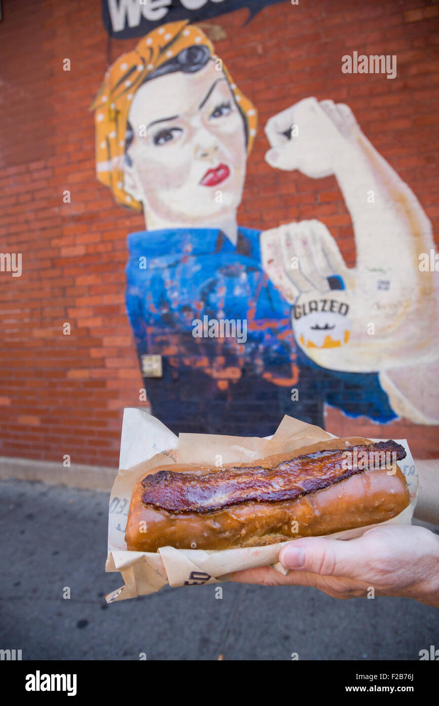 Glazed & Infused Maple Bacon Long John donut in front of the glazed mural in Wicker Park August 2, 2015 in Chicago, Illinois, USA. Stock Photo