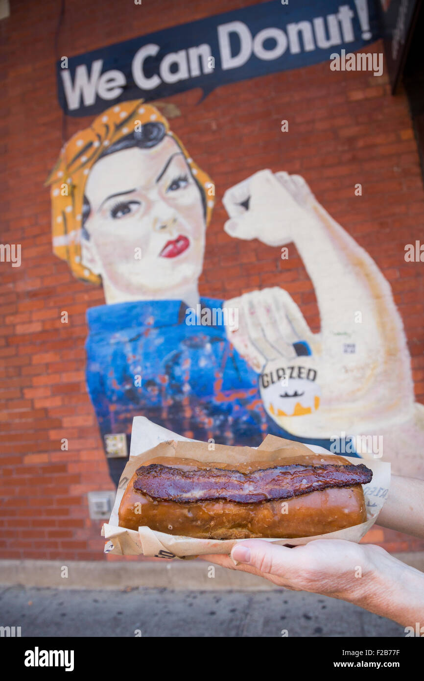 Glazed & Infused Maple Bacon Long John donut in front of the glazed mural in Wicker Park August 2, 2015 in Chicago, Illinois, USA. Stock Photo