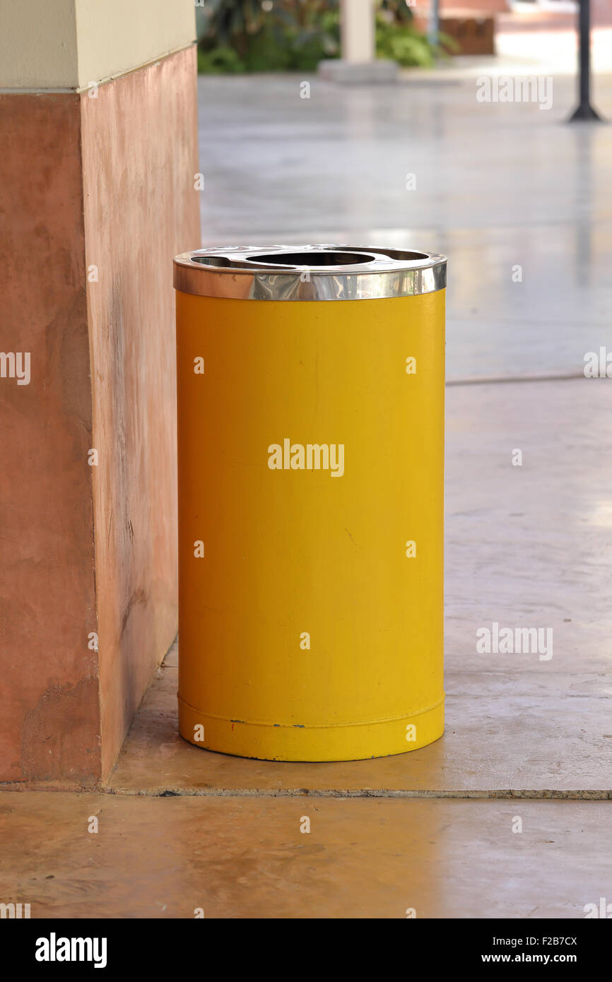 yellow metal cylinder bin on the sidewalk Stock Photo Alamy
