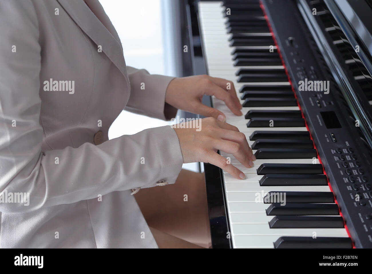 hands of a young woman playing piano Stock Photo