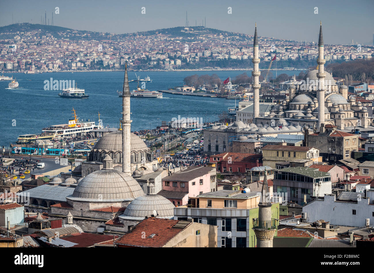Istanbul skyline, the Bosphorus, ferries sailing towards the Aisian side, Rustem Pasha and Yeni mosques at Eminonou in foregroun Stock Photo