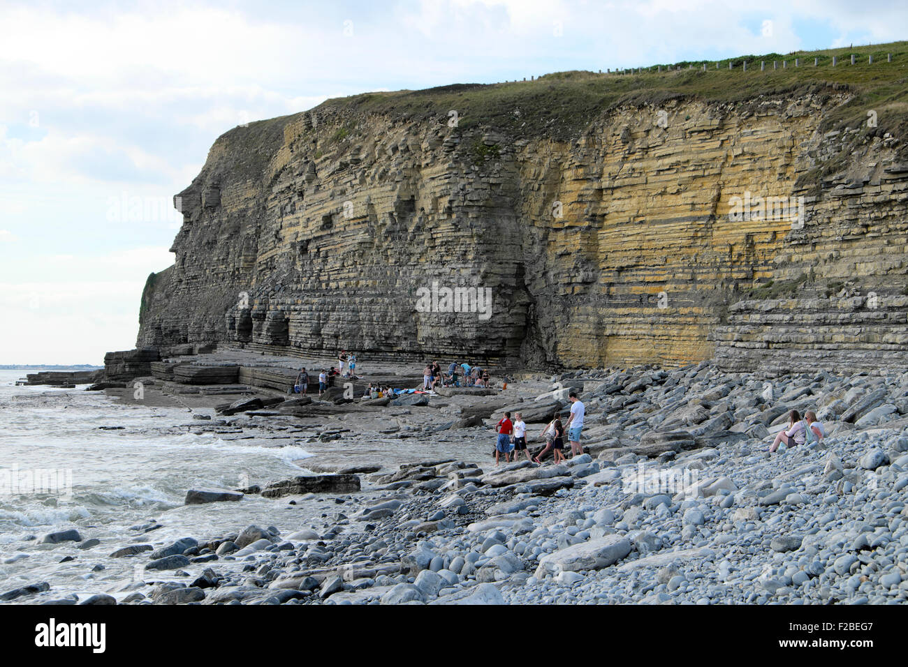 People on the stony beach at Dunraven Bay Wales UK  KATHY DEWITT Stock Photo
