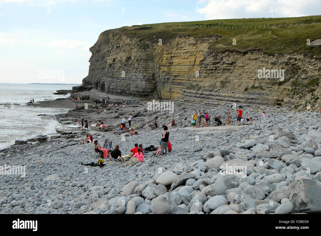 People on the stony beach at Southerndown, Dunraven Bay Wales UK  KATHY DEWITT Stock Photo