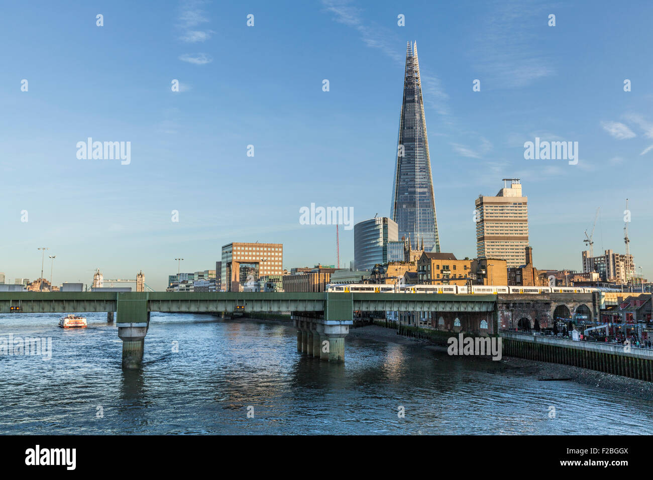 Southwark Bridge in London by the River Thames with the Shard Southwark Cathedral Guys Hospital &Tower Bridge in the background Stock Photo