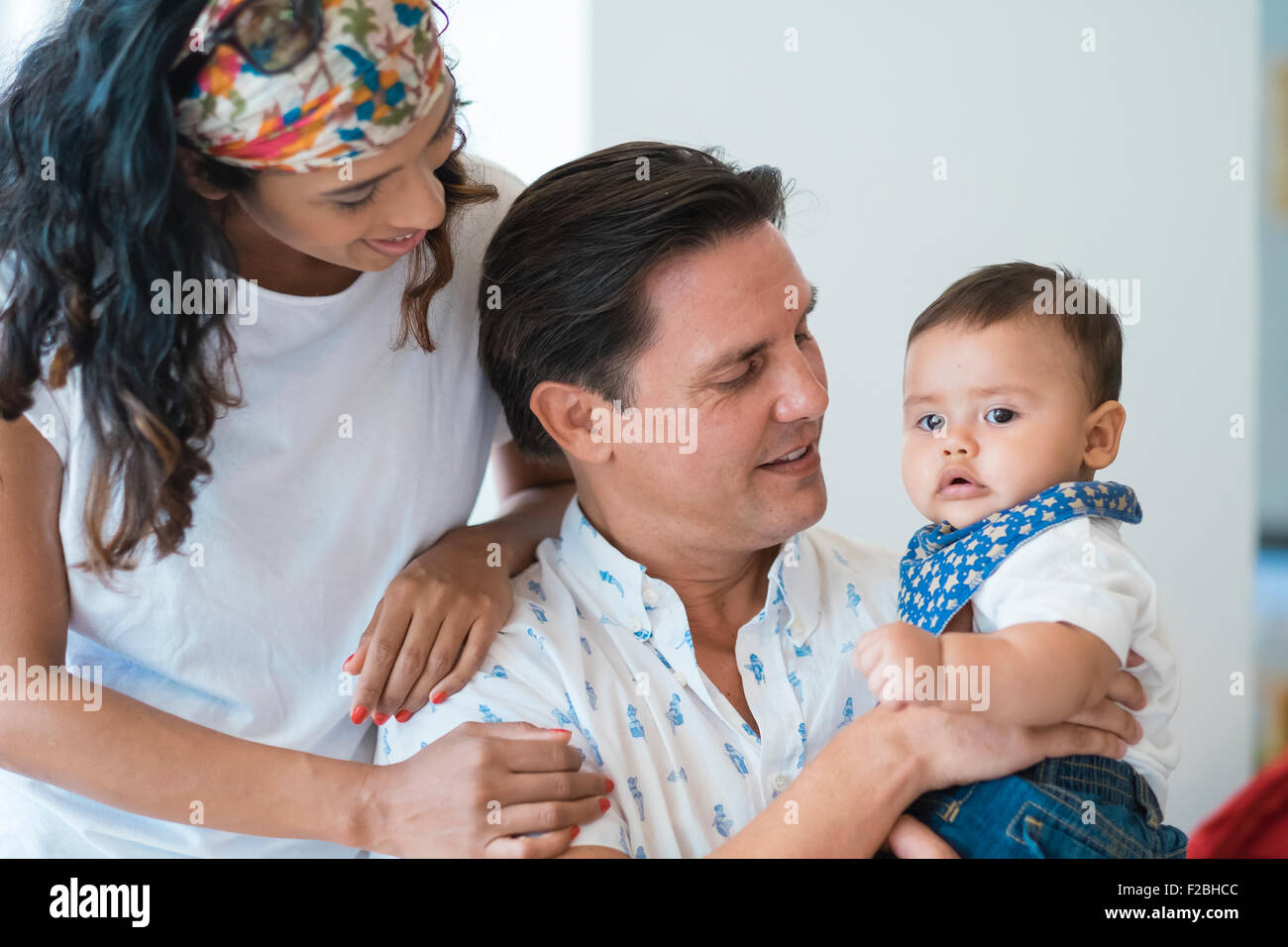 Family of hispanic mother, caucasian father and multi ethnic baby son Stock Photo