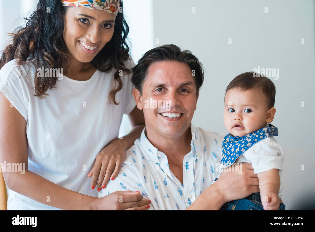 Young family with baby boy smiling at camera Stock Photo