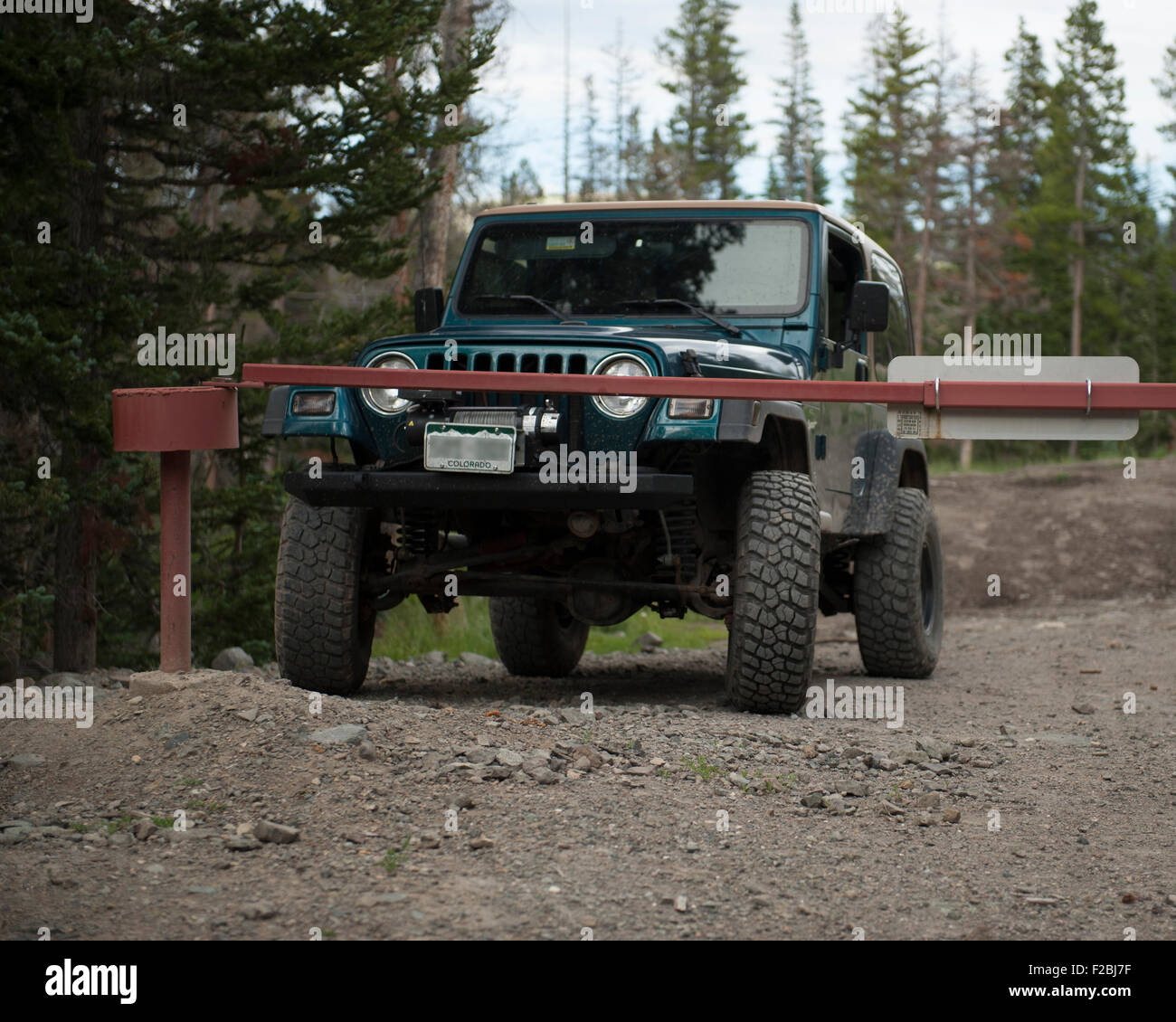 A four-wheel-drive Jeep at a locked gate Stock Photo