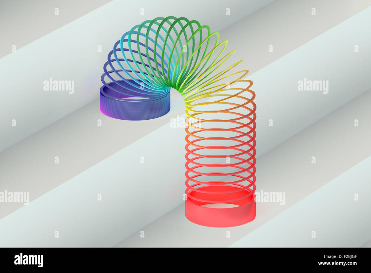 Rainbow colored plastic Slinky toy Stock Photo