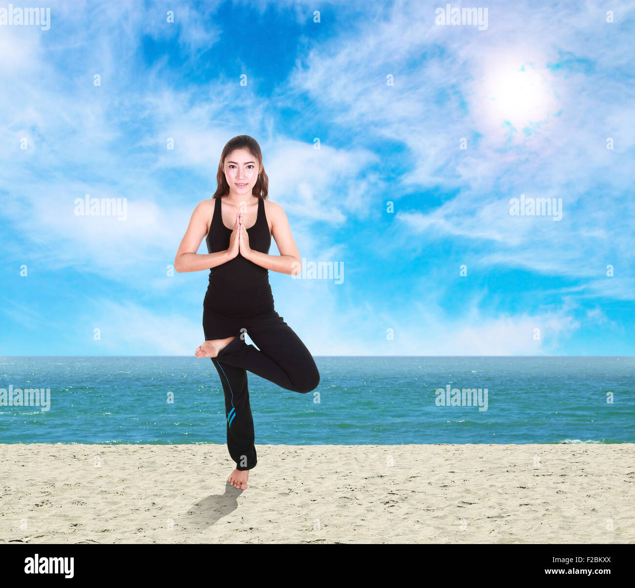 Young woman doing yoga exercise on the beach Stock Photo Alamy