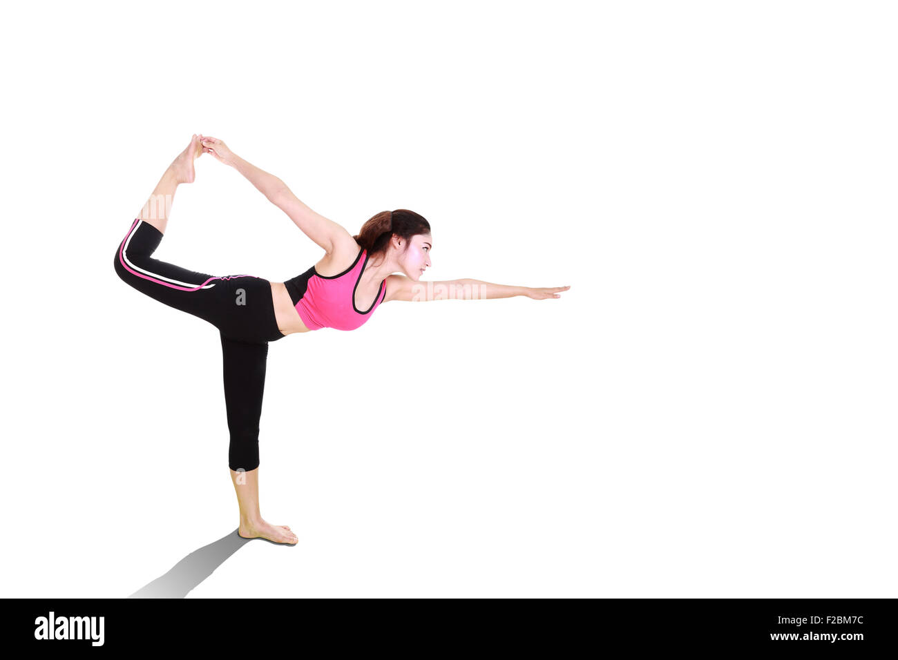 Young woman doing yoga exercise isolated on white background Stock ...