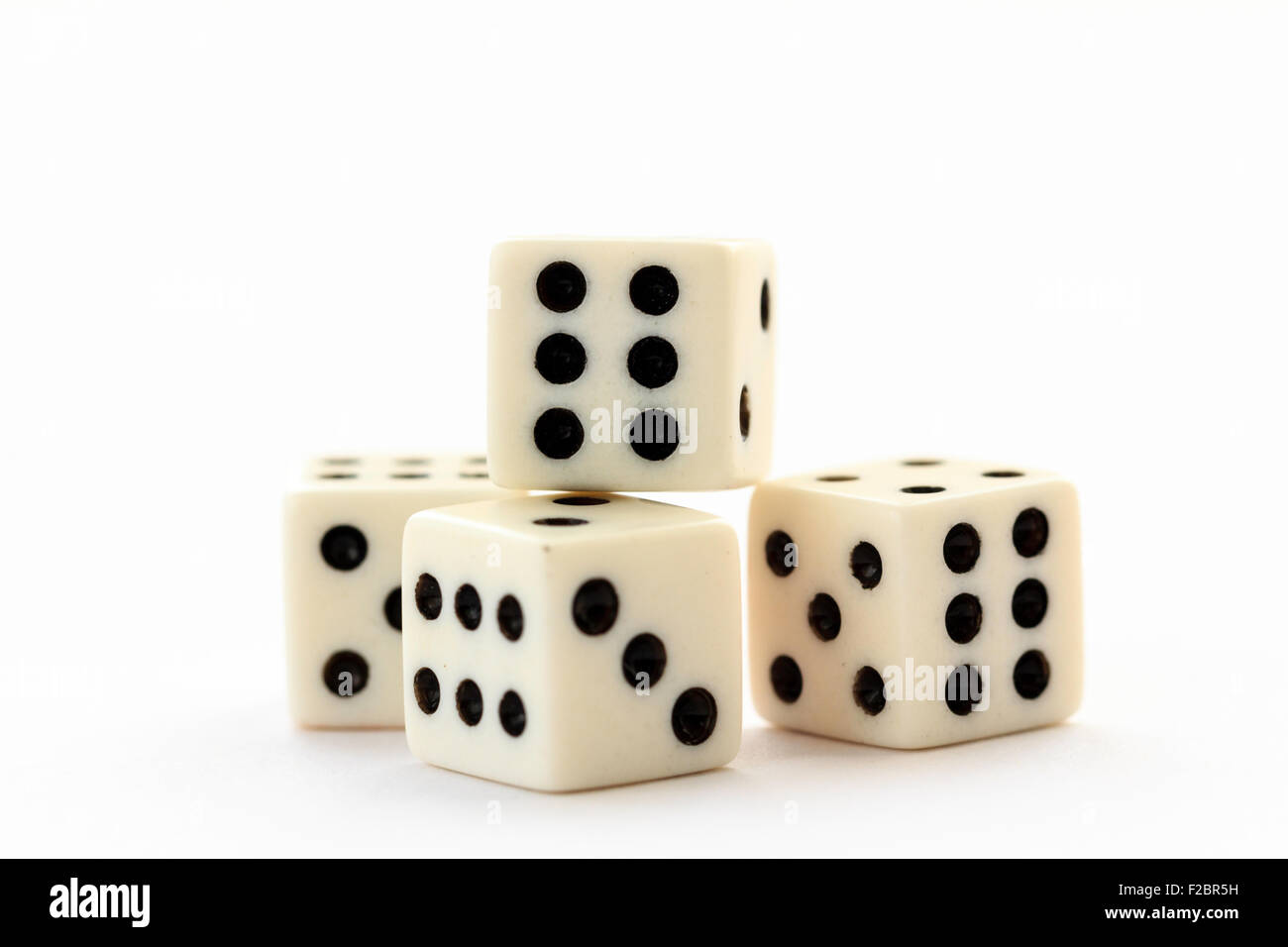 Four white dice with black spots and red single one on illuminated white  plain background Stock Photo - Alamy