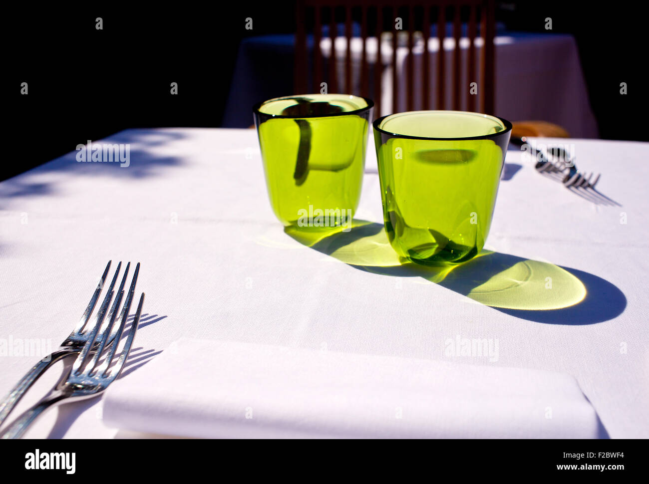 Green glasses on set table Stock Photo