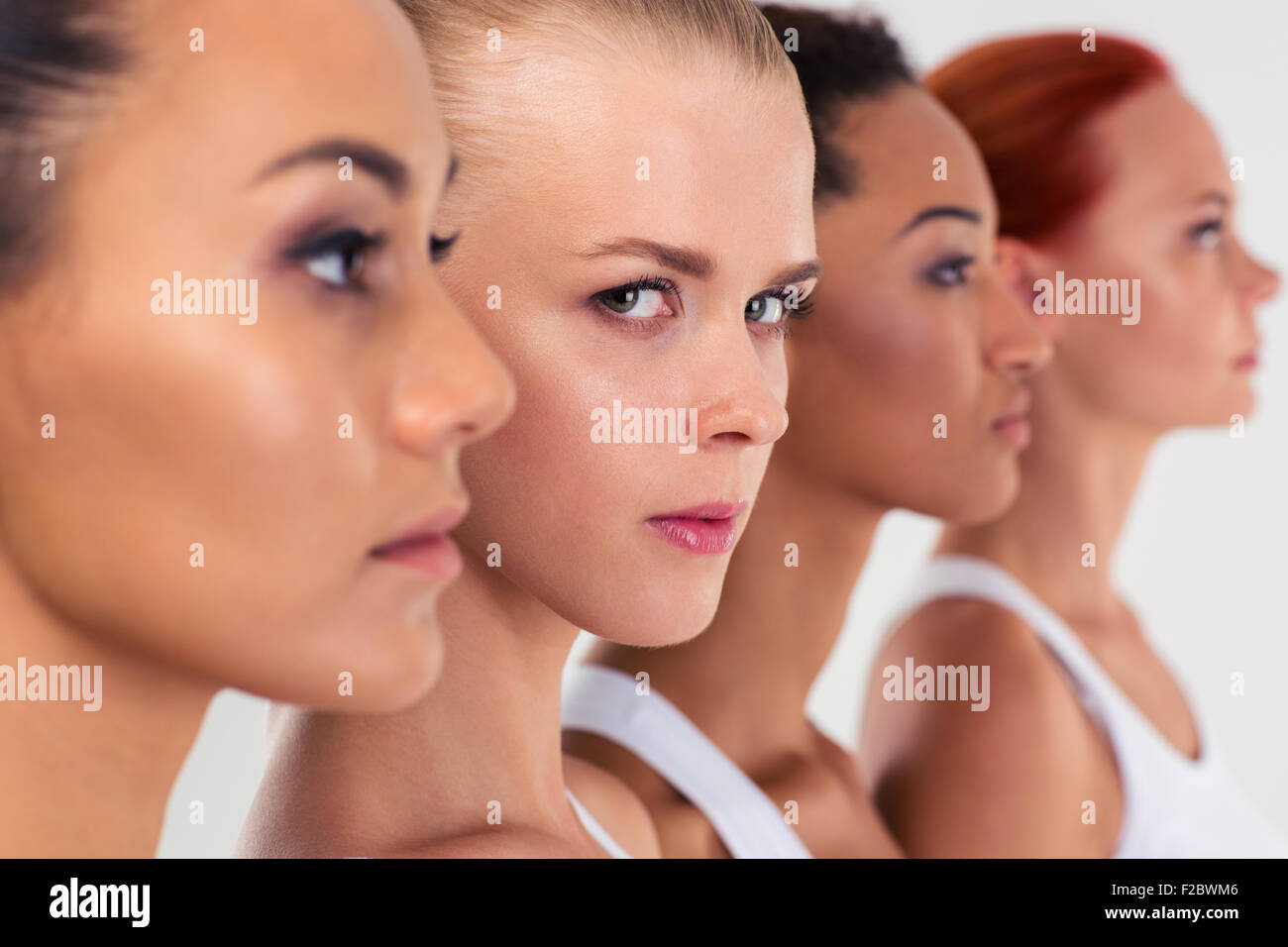 Portrait of a serious four woman standing in a row Stock Photo