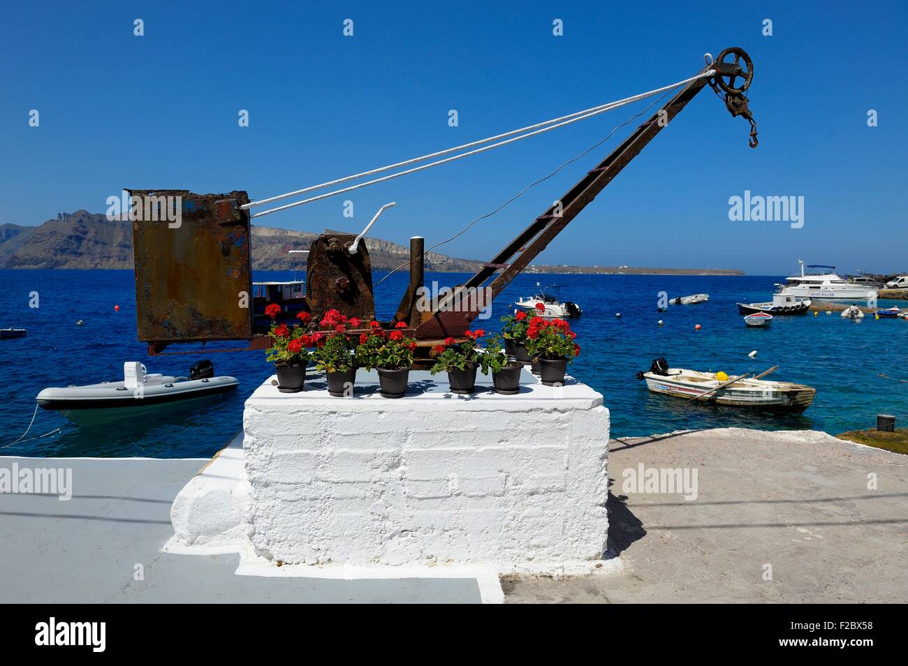 A rusty harbour boat crane in Amoudi bay Santorini,Greece Stock Photo