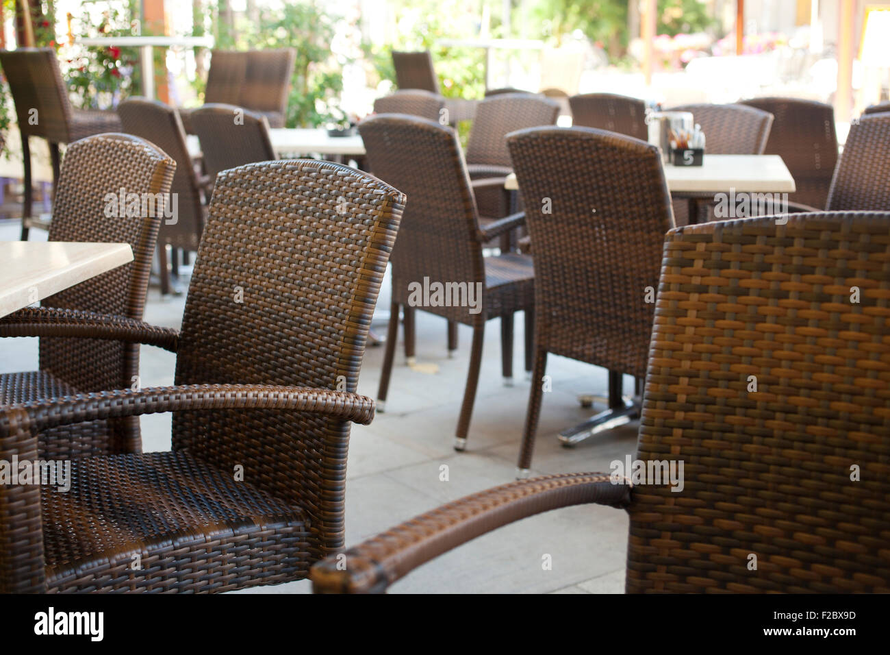 Table and wicker chairs of a coffee bar Stock Photo - Alamy