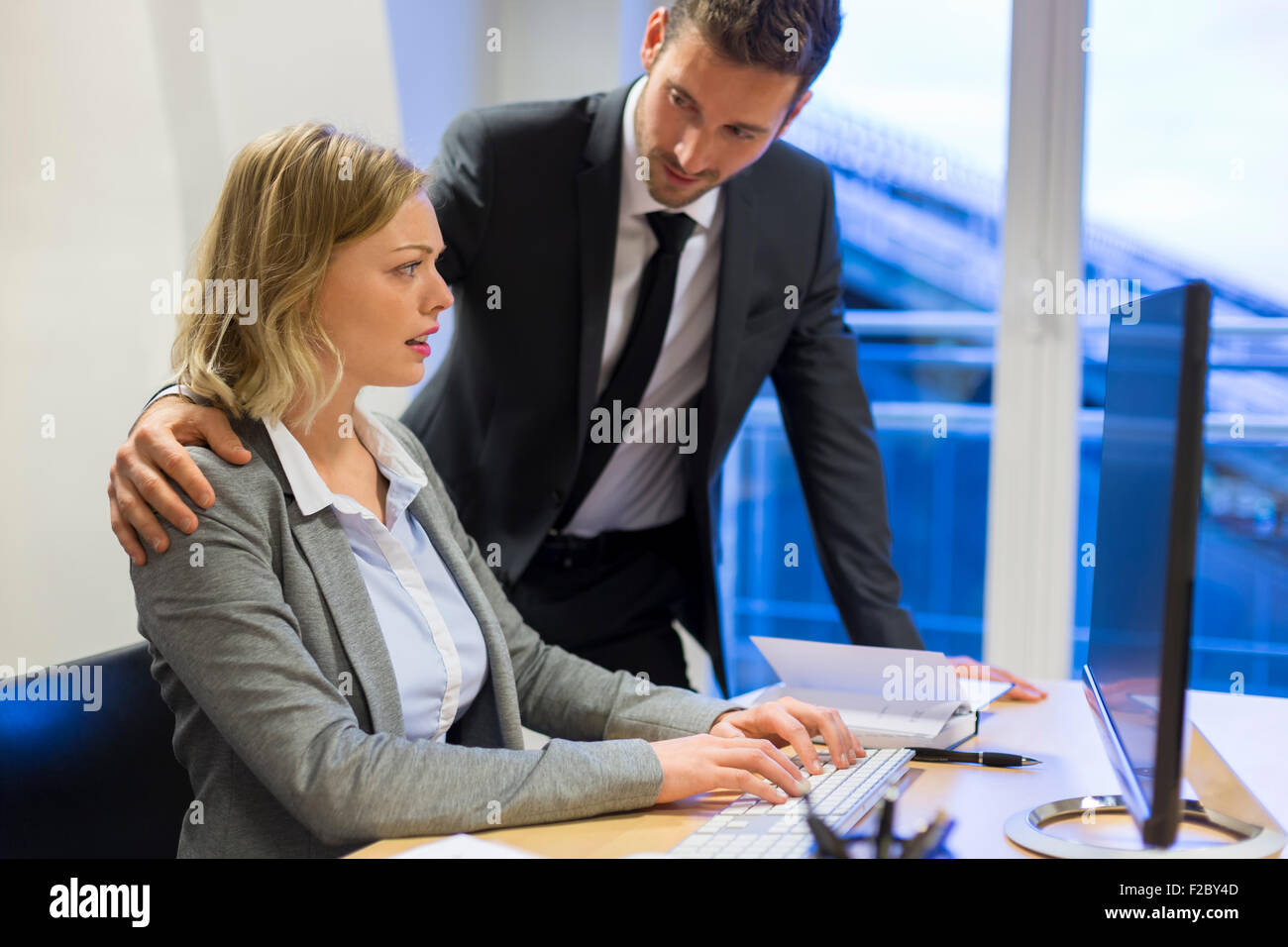 reassuring businessman with stressed colleague in office Stock Photo