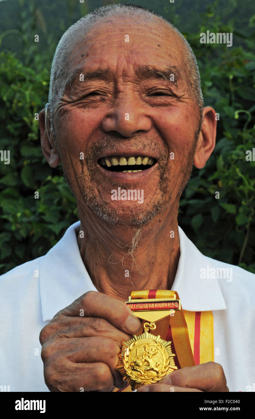 Tiantai, Zhejiang, China. 16th September, 2015. Photo taken on Sept. 11, 2015 shows Yao Renyan, a 93-year-old receiver of the commemorative medal of the 70th anniversary of the Victory of Chinese People's War of Resistance Against Japanese Aggression and a veteran of the Volunteer Corps of Tiantai County in east China's Zhejiang Province. Yao joined the corps 10 days after his wedding and fought against the Japanese invaders in five provinces of China. He retired after the war as a lieutenant and returned home to be a farmer. Credit:  Xinhua/Alamy Live News Stock Photo