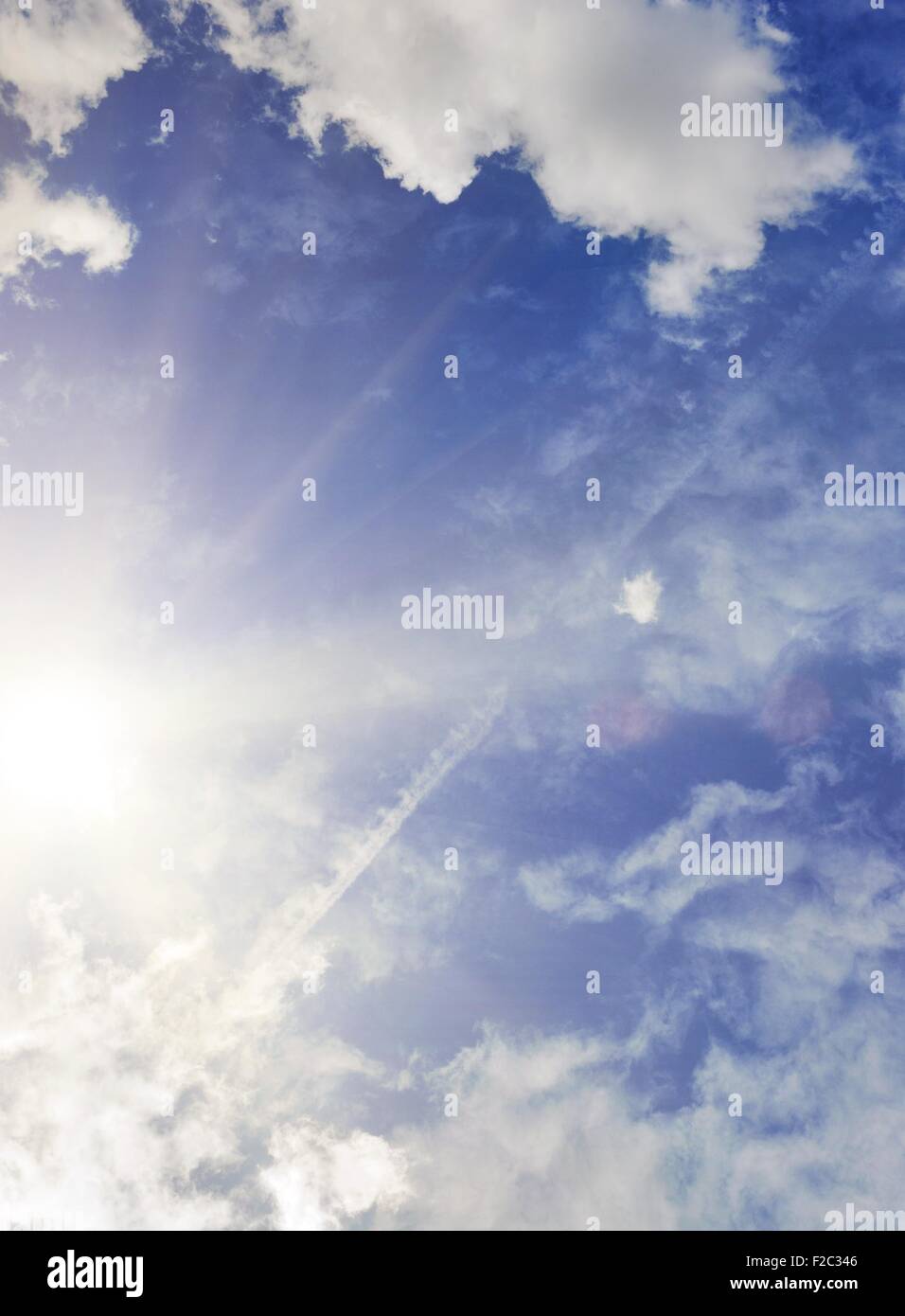 Blue sky with fluffy clouds Stock Photo - Alamy