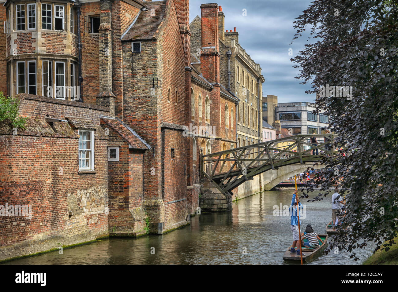 Punting under the  'mathematical bridge' over the river cam at Cambridge. Stock Photo