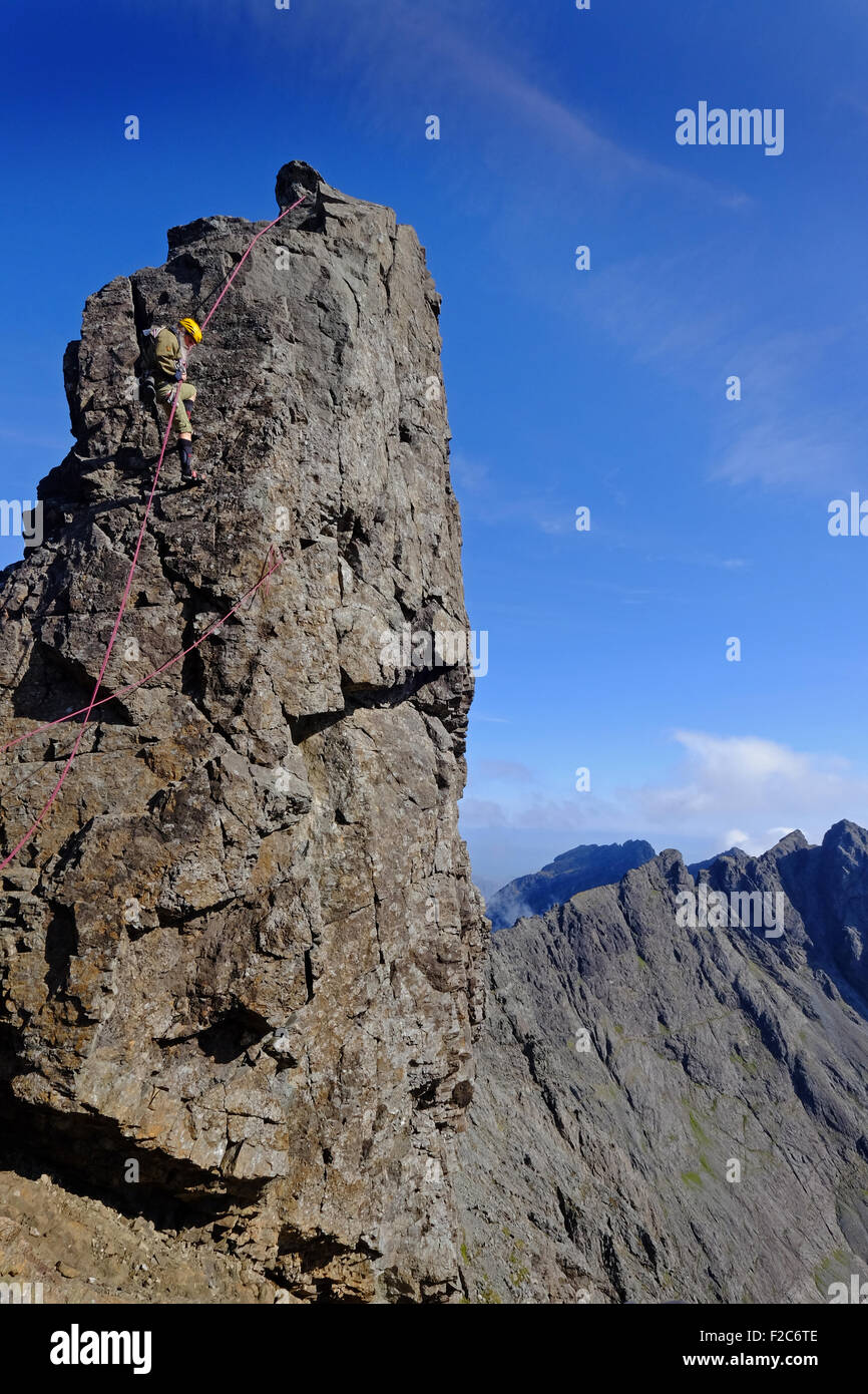 A climber abseiling down The Inaccessible Pinnacle on the Cuillin Ridge, Skye, Scotland Stock Photo