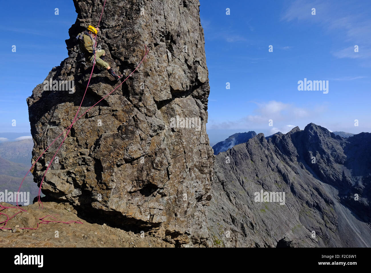 A climber abseiling down the The Inaccessible Pinnacle on the Cuillin Ridge, Skye, Scotland Stock Photo