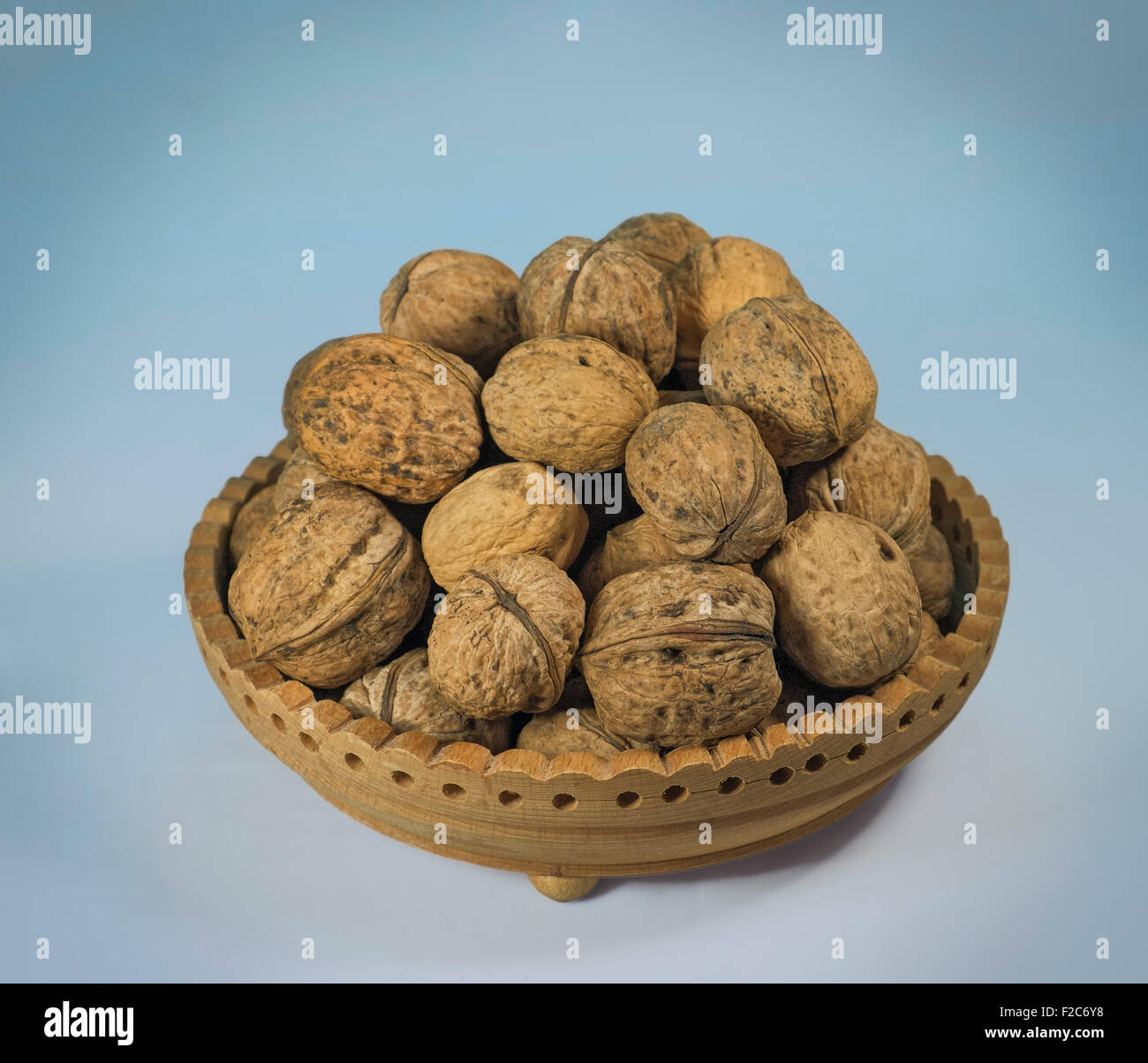 Wood dish full of walnuts Stock Photo Alamy