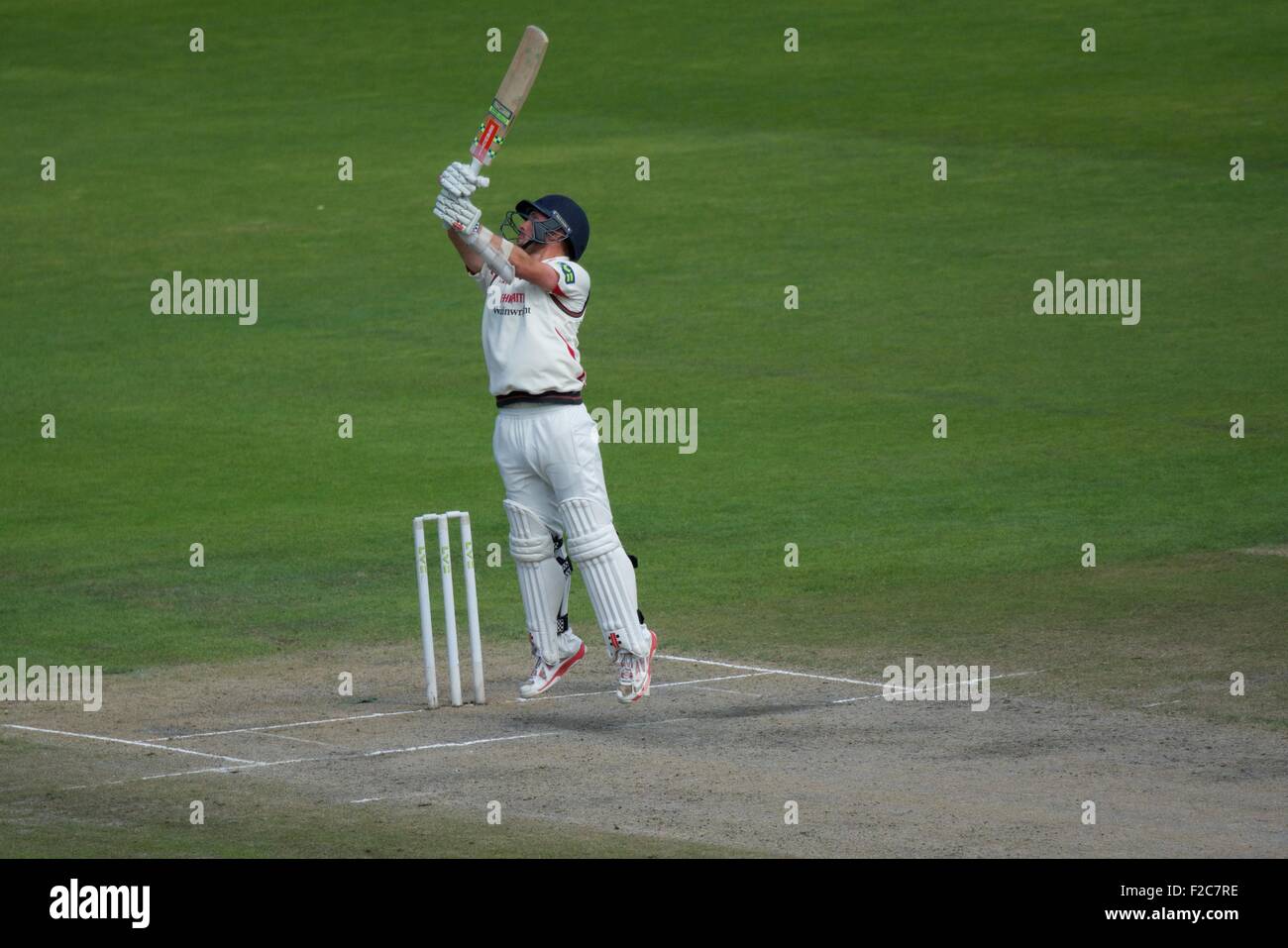 Manchester, UK  16th September 2015  Simon Kerrigan Lancashire) stretches to reach a bouncer on the third day of  their top of the table match against Surreyat Emirates Old Trafford. County Cricket  Lancashire v Surrey   Manchester, UK Credit:  John Fryer/Alamy Live News Stock Photo