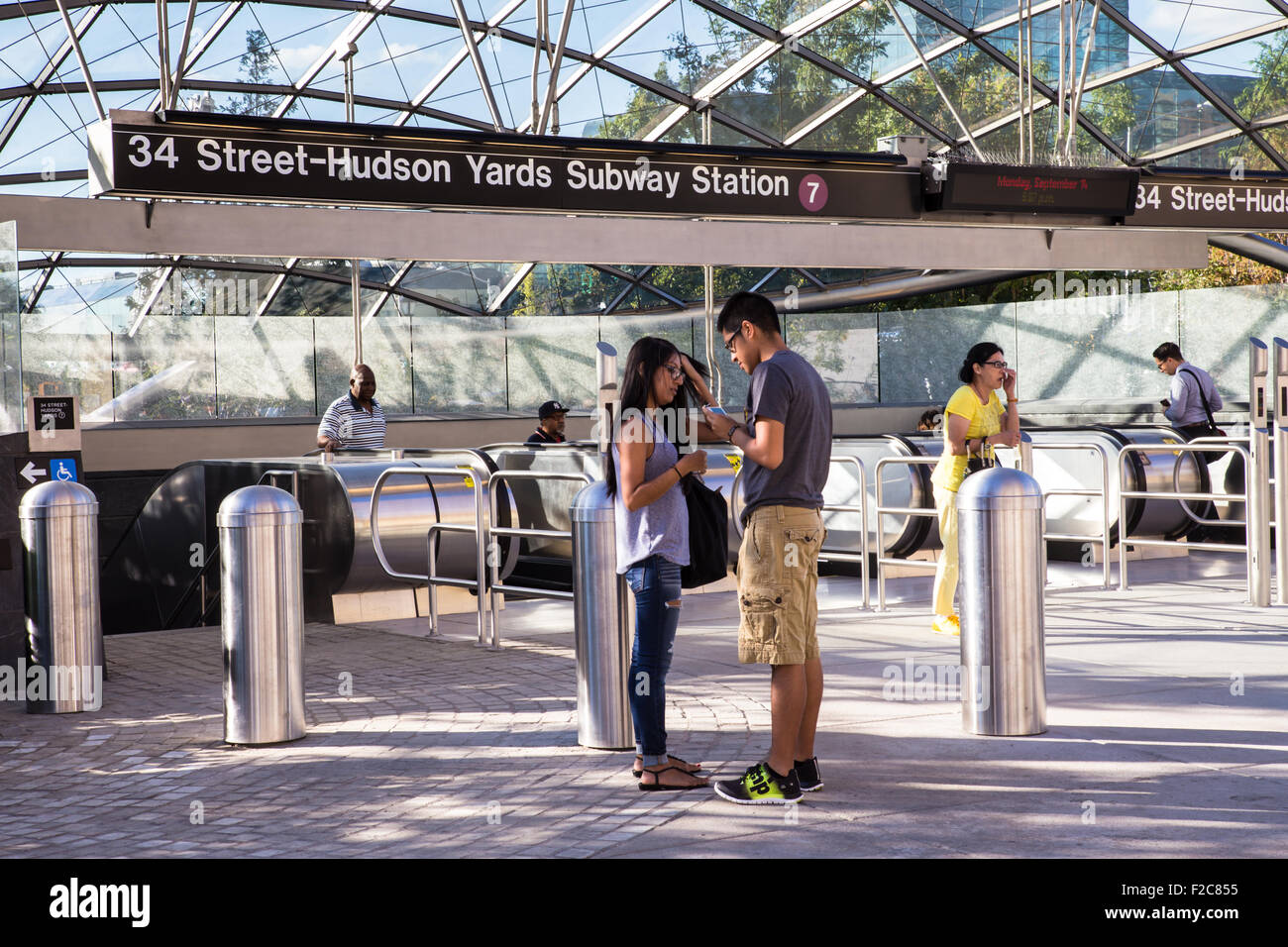 Street view at new Hudson Yards 7 train subway station with travelers visible. Stock Photo