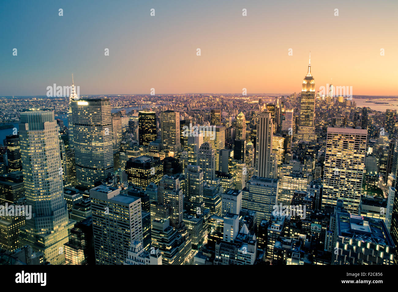 Beautiful New York City Manhattan buildings lit up at sunset Stock Photo