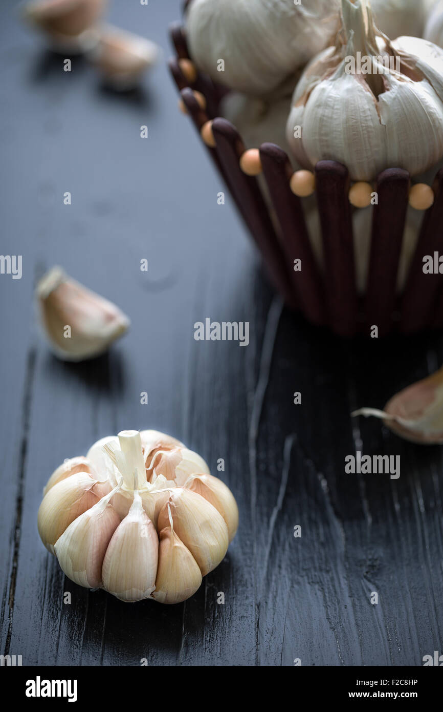 Raw garlic on black wooden table background Stock Photo - Alamy