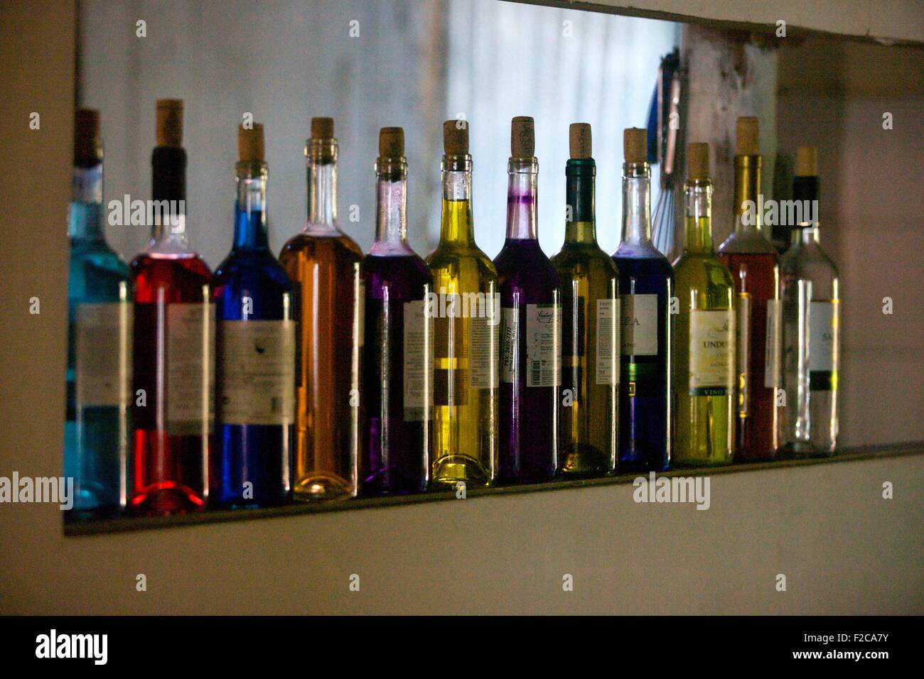 twelve multicolored bottles of liquors on a bar shelf Stock Photo Alamy