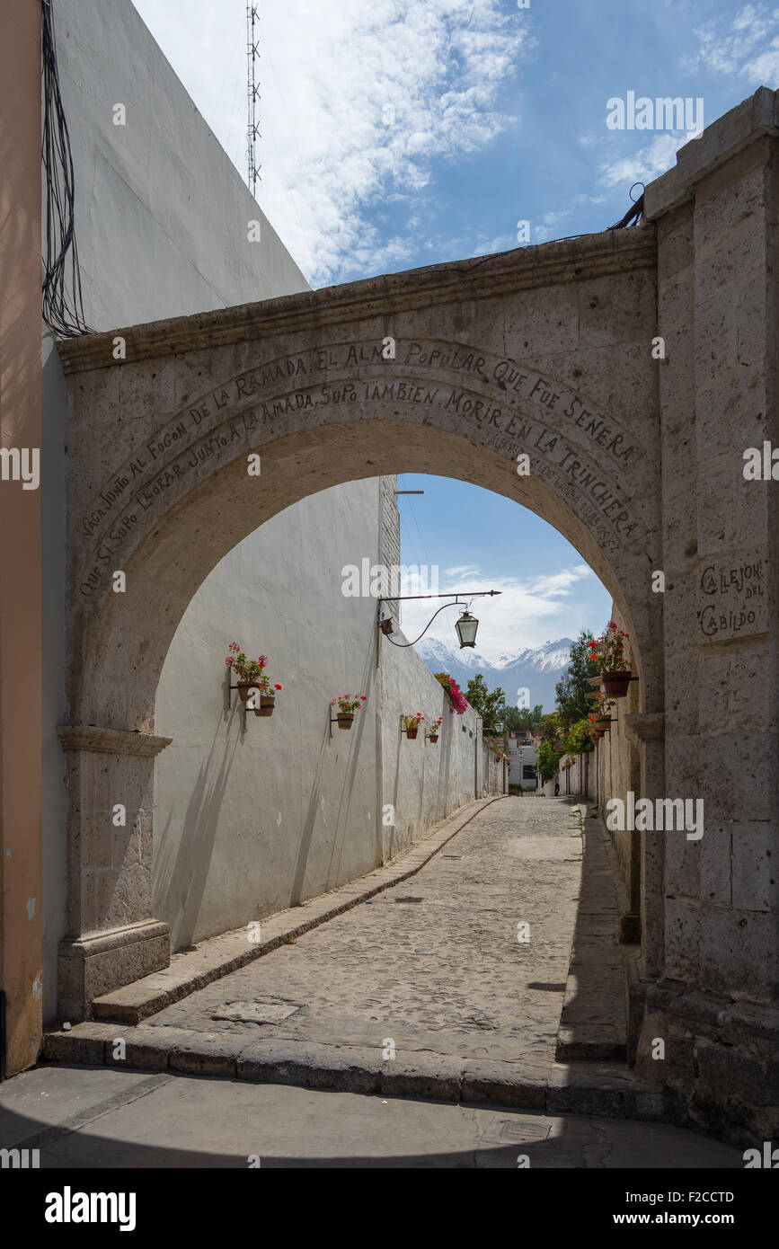 Volanic stone arch and alley in Arequipa, famous travel destination and landmark in Peru, with Volcano 'El Misti' framed into. Stock Photo