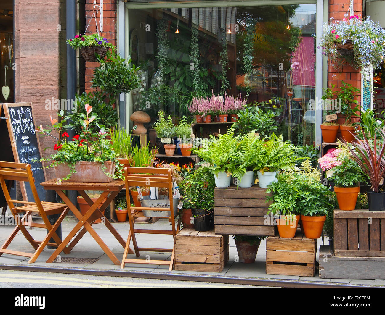 Flower shop pavement and window display in Tib Street, in the northern quarter of Manchester city centre, England, UK. Stock Photo