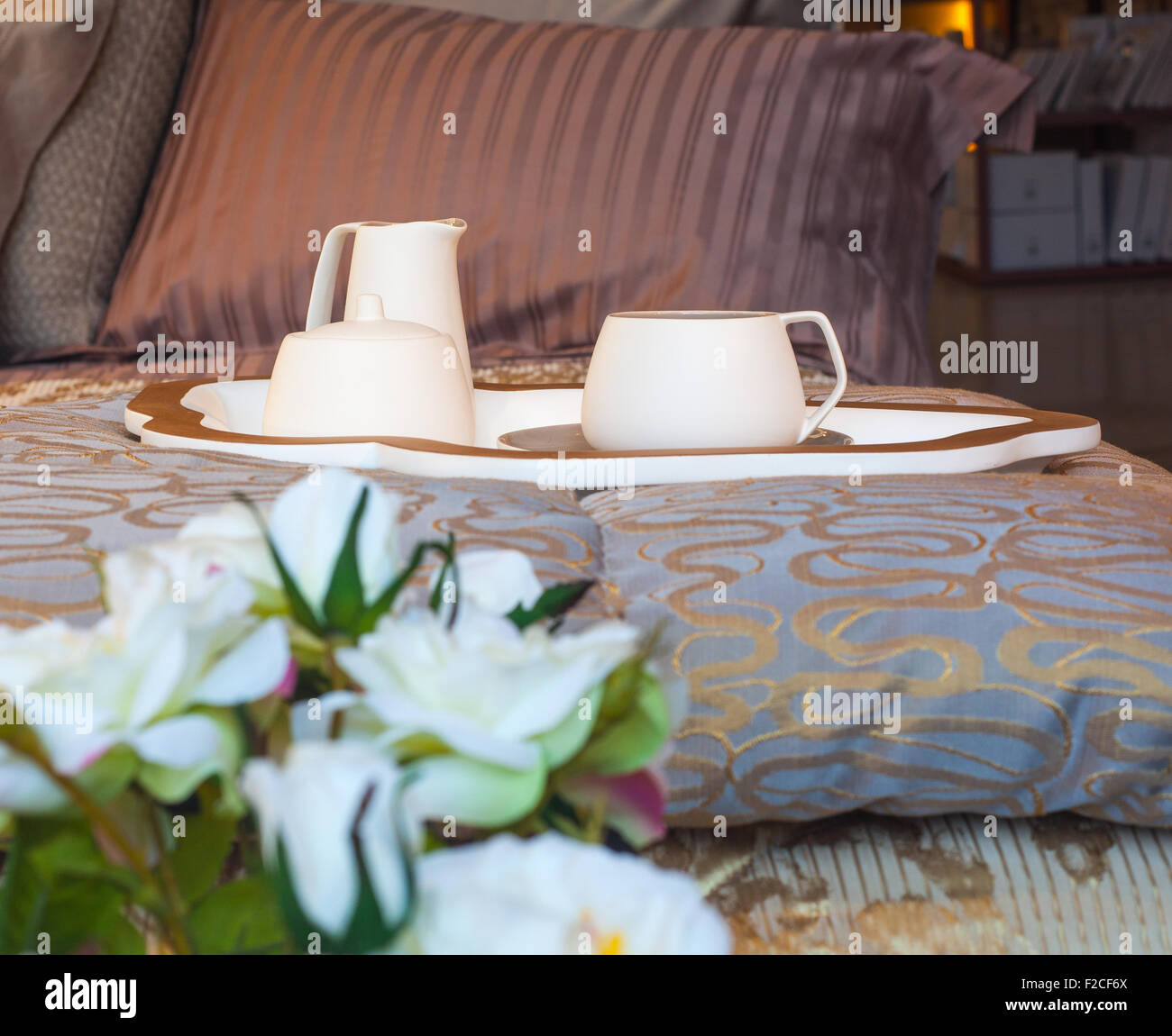 Flatware and white flowers on the bed Stock Photo