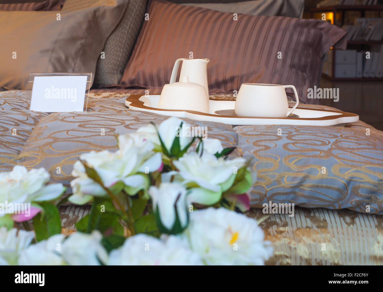 Flatware and white flowers on the bed Stock Photo