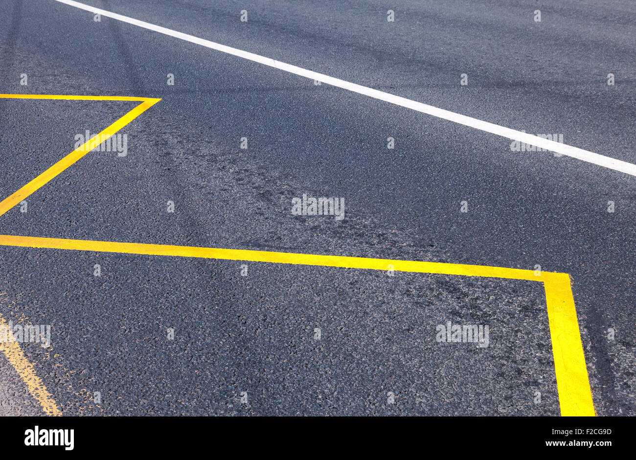 Yellow Bus Stop sign painted on the asphalt closeup Stock Photo