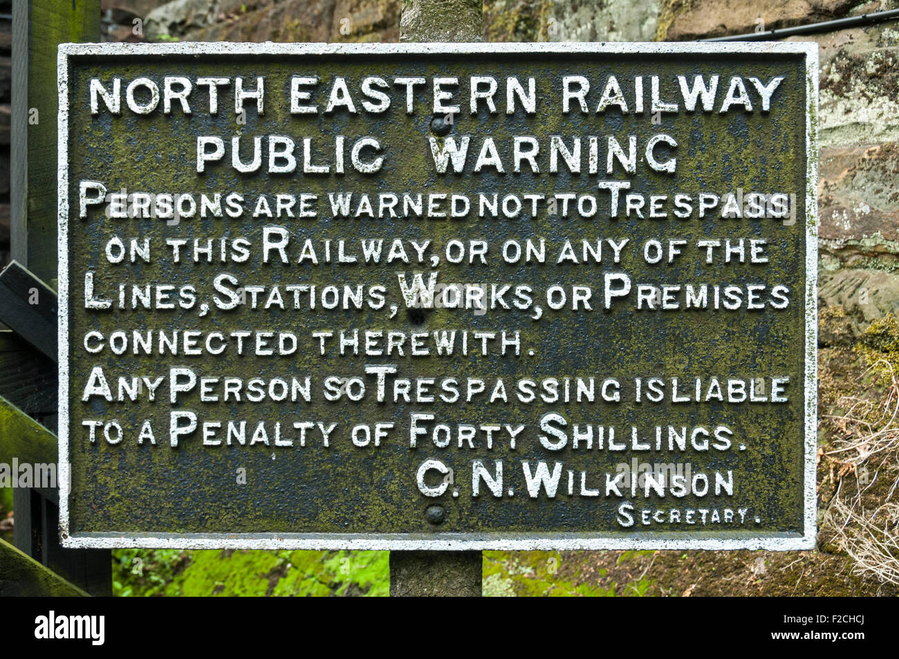 Vintage iron trespass warning sign on the North Yorkshire Moors Railway, near Grosmont Station, Yorkshire, England, UK Stock Photo