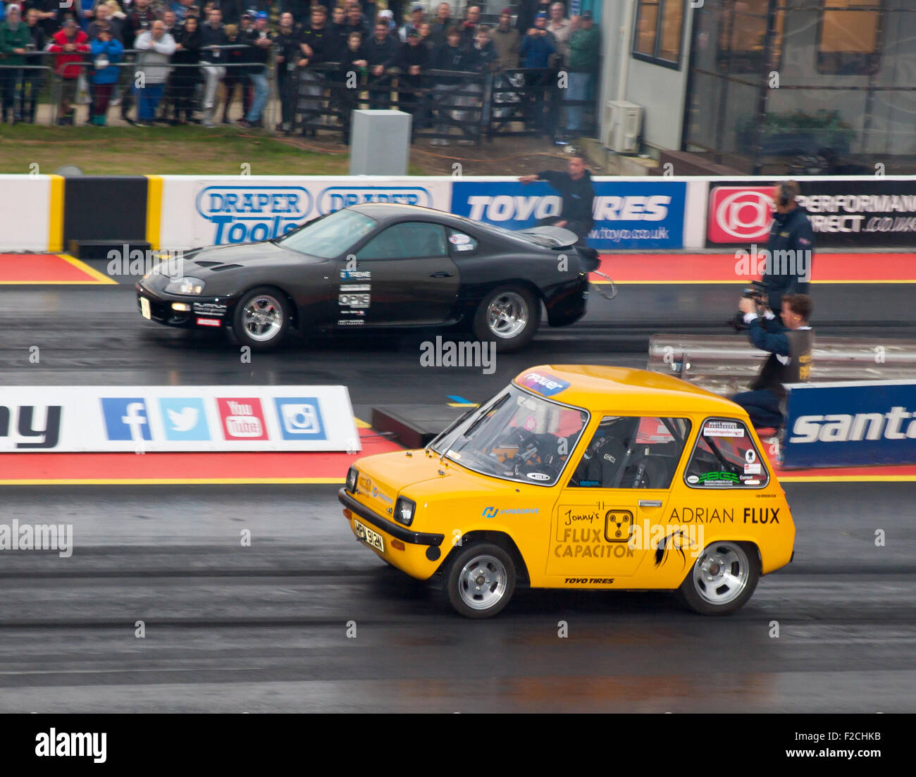 Electric car drag racing in the Pro ET class at Santa Pod. Jonny Smith nearside driving an Enfield 8000. Stock Photo