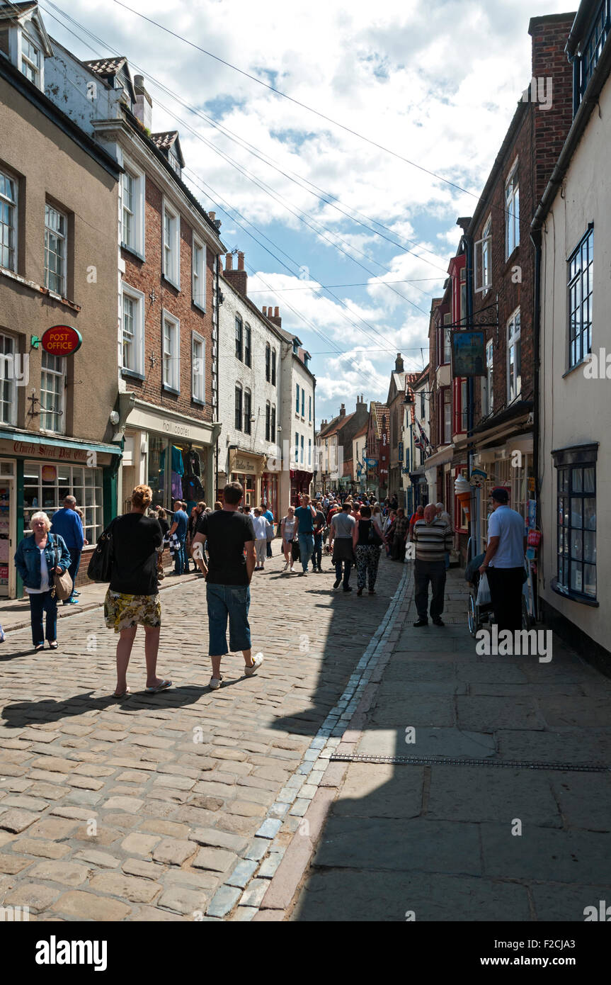 Shoppers and tourists in Church Street, Whitby, Yorkshire, England, UK Stock Photo