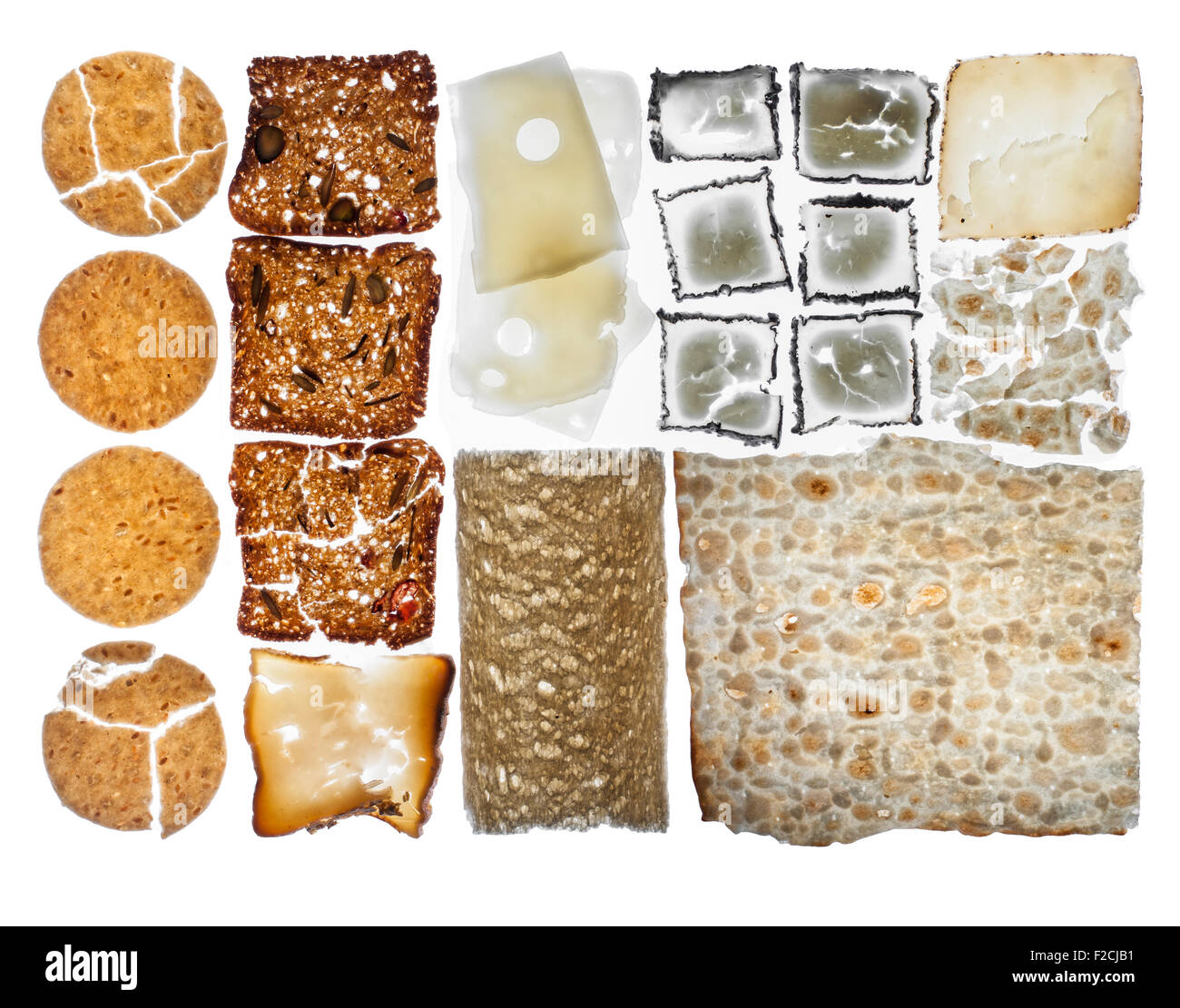 overhead view of crackers and cheese arranged in grid on light table Stock Photo