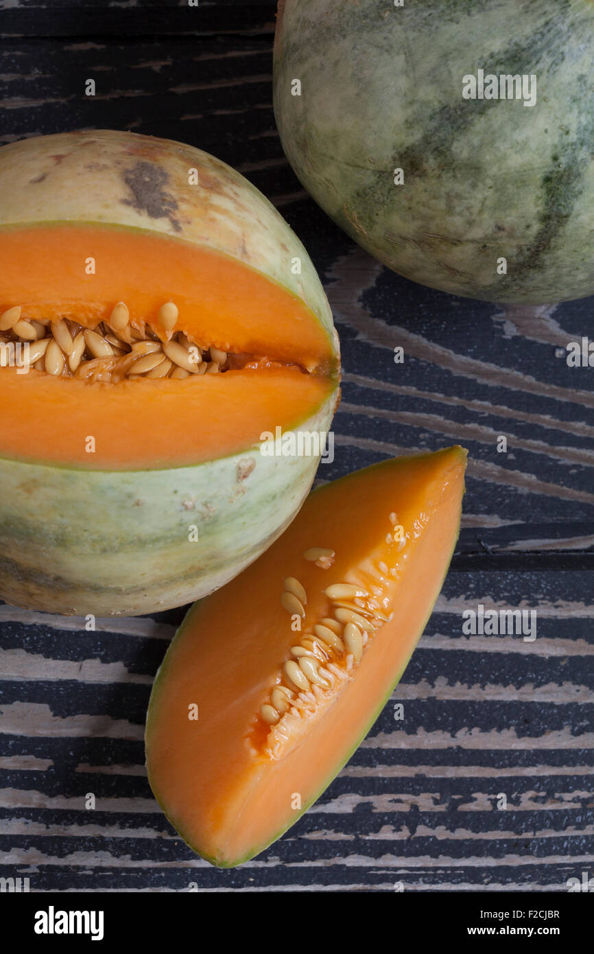 Charentais Melons are grapefruit sized melon with pale blusih-green to creamy yellos with dark green stripes. Stock Photo