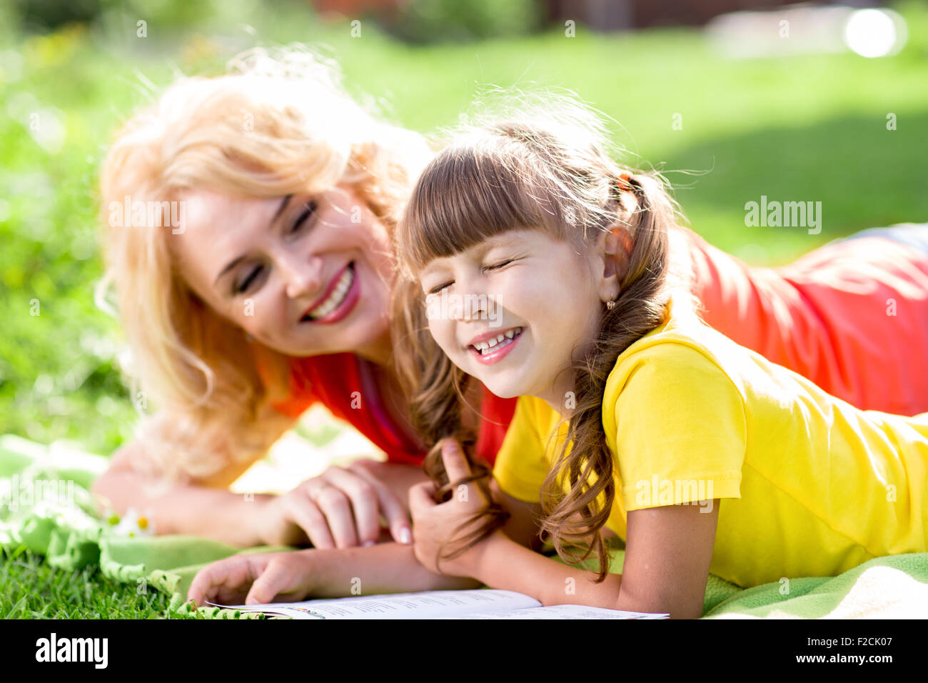 Child having picnic and reading book in summer park Stock Photo